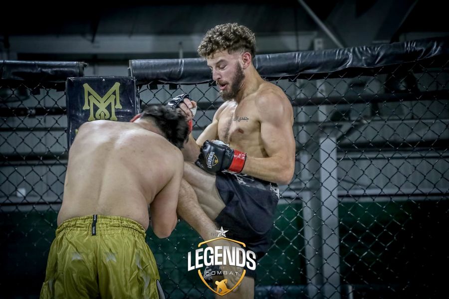 Coach Elijah Halloun landing a knee in the cage