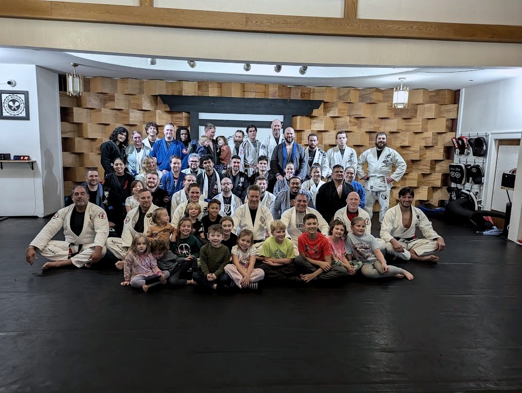 Members of all ages, kids through adults, together on the mat